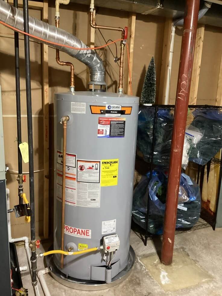 A utility-area water heater installation with new piping.